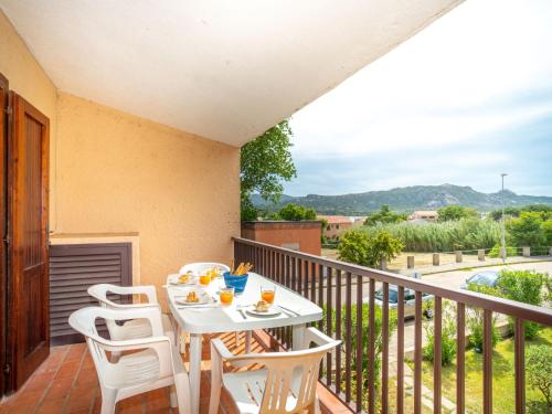 a patio with a table and chairs on a balcony at Apartment Residenza Mediterranea-3 by Interhome in Cannigione