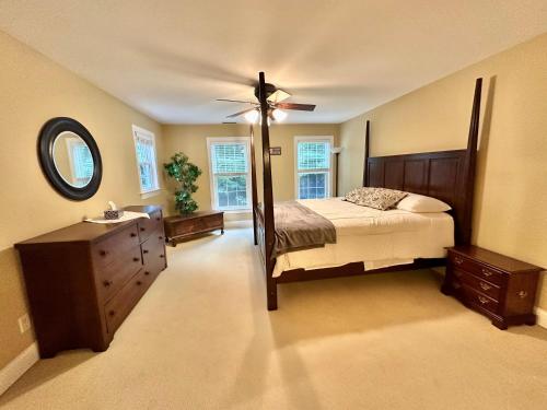 a bedroom with a bed and a dresser and a mirror at Redbud Retreat in Centerville