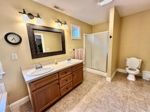 a bathroom with a sink and a toilet and a mirror at Redbud Retreat in Centerville