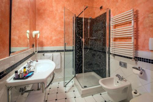 a bathroom with a sink and a shower and a toilet at Hotel San Francesco in Rome