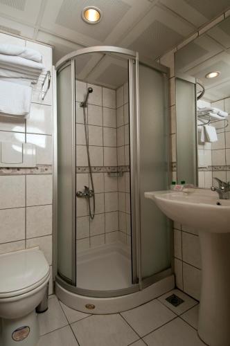 a bathroom with a shower and a toilet and a sink at Haydarpasa Hotel in Istanbul