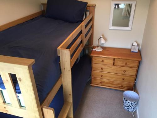 a bedroom with a bunk bed and a dresser at 94 High Street in Cross Hands