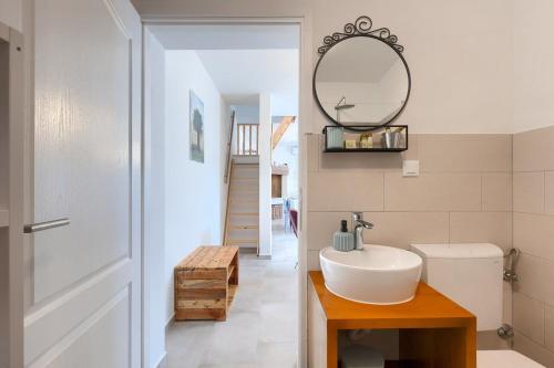 a bathroom with a white sink and a mirror at House Lando in Pula