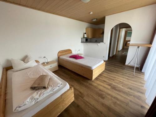 ein kleines Schlafzimmer mit 2 Betten und eine Küche in der Unterkunft Appartement 2 - b66205 in Rohrdorf
