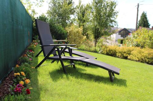 a bench sitting on the grass in a yard at Ca’Benvenuto in Doische