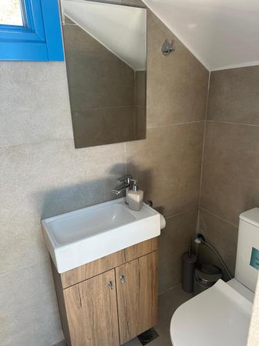 a bathroom with a sink and a toilet at Amuse Mykonos Boutique Hotel in Mýkonos City