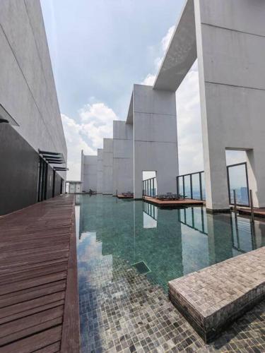a large building with a swimming pool in front of it at Harmonee Homes at The Hub SS2, PJ in Petaling Jaya