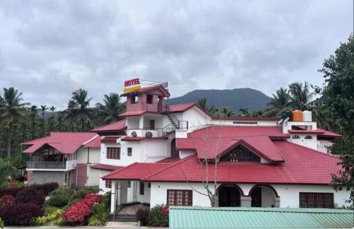 a building with a red roof on top of it at NAVARATHNA International resort in Sollebail