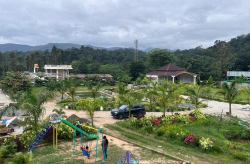 a park with a slide and a playground at NAVARATHNA International resort in Sollebail