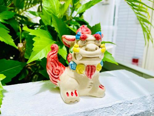 a figurine of a cow with a bird on a table at Sunset Beach Vacation House in Chatan