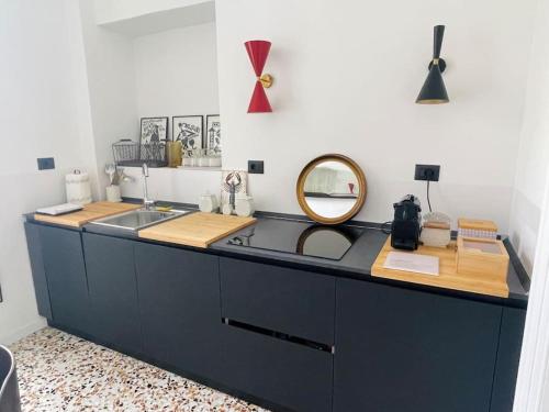 a kitchen counter with a sink and a mirror at L'Adagio in Gran Madre in Turin