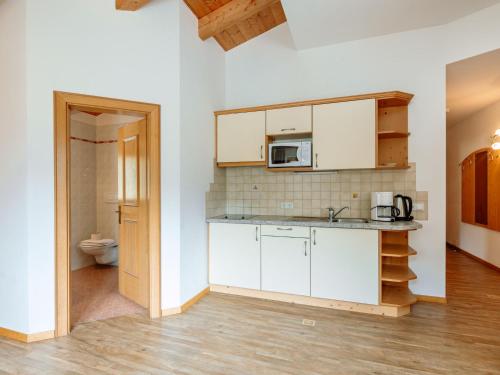 a kitchen with white cabinets and a sink at Apartment Nr- 17 by Interhome in Solda