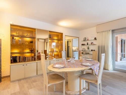 a kitchen and dining room with a table and chairs at Apartment Port de la Gavine I-3 by Interhome in Hyères