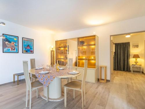 a dining room with a table and chairs at Apartment Port de la Gavine I-3 by Interhome in Hyères