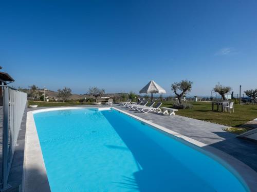 a swimming pool with blue water in a resort at Apartment Alba Marina by Interhome in Citta' Sant'Angelo
