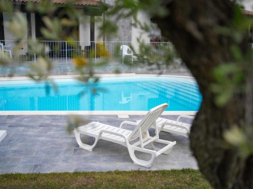 two lounge chairs next to a swimming pool at Apartment Alba Marina by Interhome in Citta' Sant'Angelo