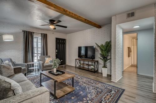a living room with a couch and a tv at Lavish style 2BR in Stillwater with Free Parking and WiFi in Stillwater