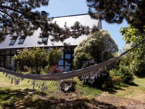 a hammock in front of a house at Holiday Home La belle vue by Interhome in Cancale