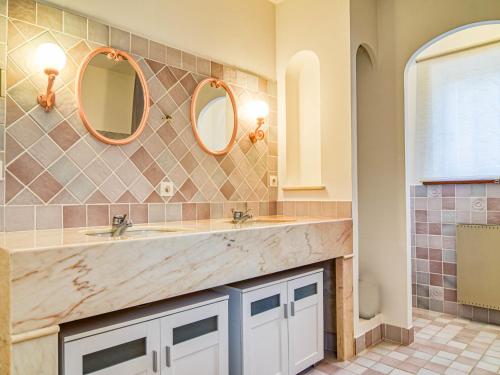 a bathroom with two sinks and two mirrors at Holiday Home Le Belvédère d'Estelle by Interhome in Pierrefeu-du-Var