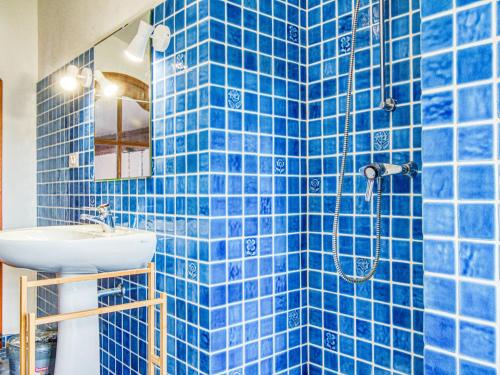 a blue tiled bathroom with a sink and a shower at Holiday Home Le Belvédère d'Estelle by Interhome in Pierrefeu-du-Var
