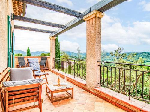 a balcony with chairs and a view of the mountains at Holiday Home Le Belvédère d'Estelle by Interhome in Pierrefeu-du-Var