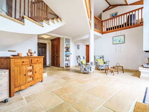 un grand salon avec une commode en bois et des chaises dans l'établissement Holiday Home Hegoasea by Interhome, à Saint-Pée-sur-Nivelle