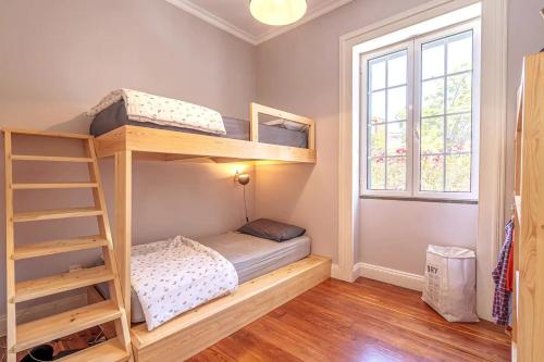 a bedroom with two bunk beds and a window at Villa Carvalhal in Funchal