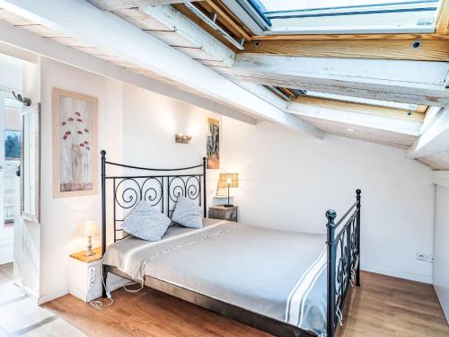 a bedroom with a bed in a room with ceilings at Apartment Les Marines-13 by Interhome in La Foux