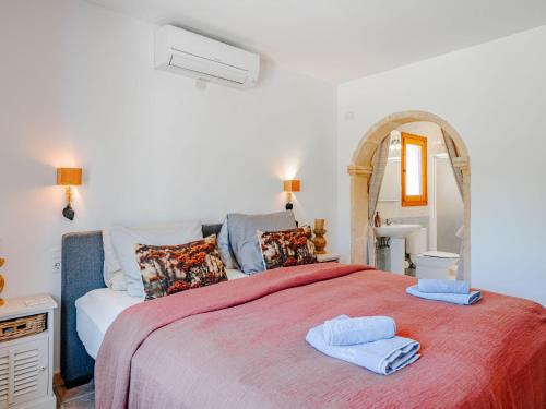 a bedroom with a large bed with two towels on it at Villa Charme by Interhome in Jávea