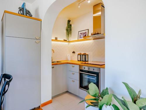 a kitchen with white cabinets and a white refrigerator at Villa Charme by Interhome in Jávea