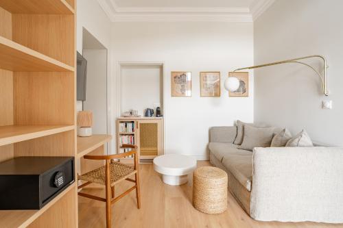 a living room with a couch and a chair at Villa Camille Hotel & Spa in Banyuls-sur-Mer