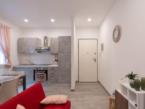 a living room with a red couch and a kitchen at Apartment Balin by Interhome in Diano Castello
