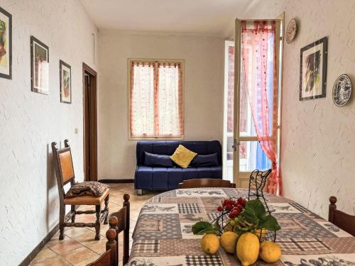 a living room with a table and a blue couch at Holiday Home Lidia by Interhome in Pianavia