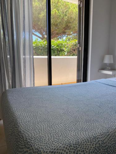 a bedroom with a bed and a large window at Blife Sun Hostel & Rooms in Faro