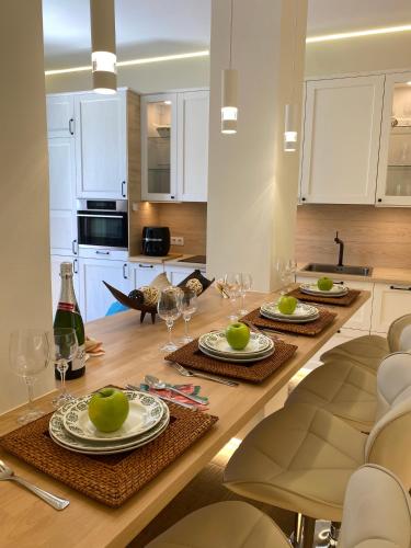 a kitchen with a table with plates and wine glasses at El balcón de la Muralla in Ávila