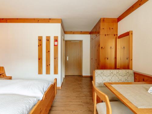 a bedroom with a bed and a dining table at Apartment Nr- 7 by Interhome in Solda