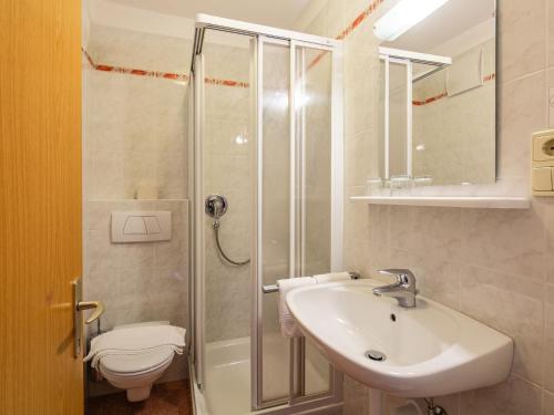 a bathroom with a sink and a shower and a toilet at Apartment Nr- 7 by Interhome in Solda