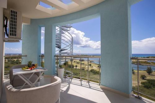 a balcony with a view of the ocean at Serenity Penthouse - The Pinnacle of Luxury in Maho Reef