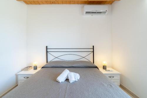 a bedroom with a bed with two towels on it at Agrivillage San Lorenzo in San Lorenzo