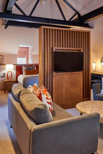 a living room with a couch and a television at Hotel Du Vin & Bistro York in York