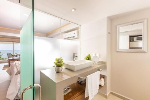 a bathroom with a sink and a mirror at Serene Beachfront Escape Includes Delicious Breakfast in Puerto Vallarta