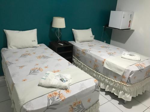 Postel nebo postele na pokoji v ubytování Lax Hotel - Acesso através de escadas - 3 andares