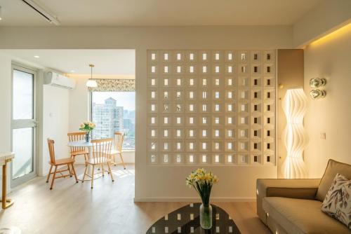 a living room with a large wall of windows at Shanghai Yi Du B&B - Near Nanjing West Road commercial district, 350 walk from the Natural History Museum subway in Shanghai