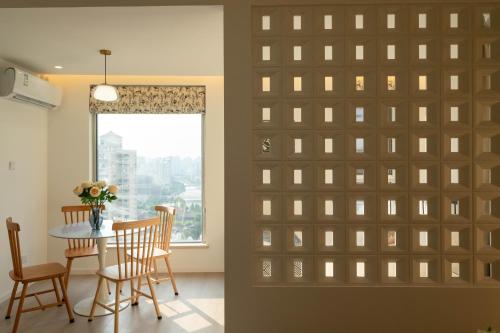 a room with a sliding door with a table and chairs at Shanghai Yi Du B&B - Near Nanjing West Road commercial district, 350 walk from the Natural History Museum subway in Shanghai