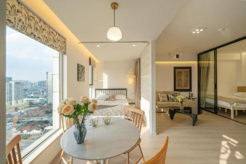 a room with a table and a bed and a bedroom at Shanghai Yi Du B&B - Near Nanjing West Road commercial district, 350 walk from the Natural History Museum subway in Shanghai