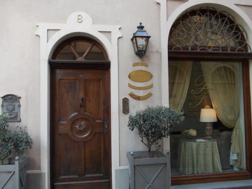 a front door of a house with a table and a lamp at Palazzo Finati in Alba