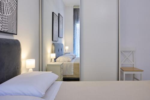 a bedroom with a bed and a mirror at Chios Downtown Apartments in Chios