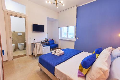 a bedroom with a large bed and a bathroom at Napodano Apartments - Napoli Salerno in Sant'Egidio del Monte Albino