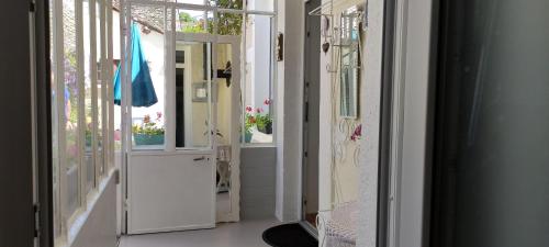 a hallway with a door open to a room with plants at Le nid de Mary in Joux-la-Ville