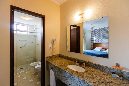 a bathroom with a sink and a mirror at Panorama Hotel in Águas de Lindóia